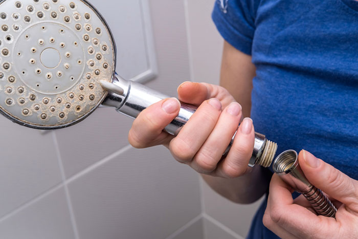 Why has my water pressure dropped – scale buildup on showerhead